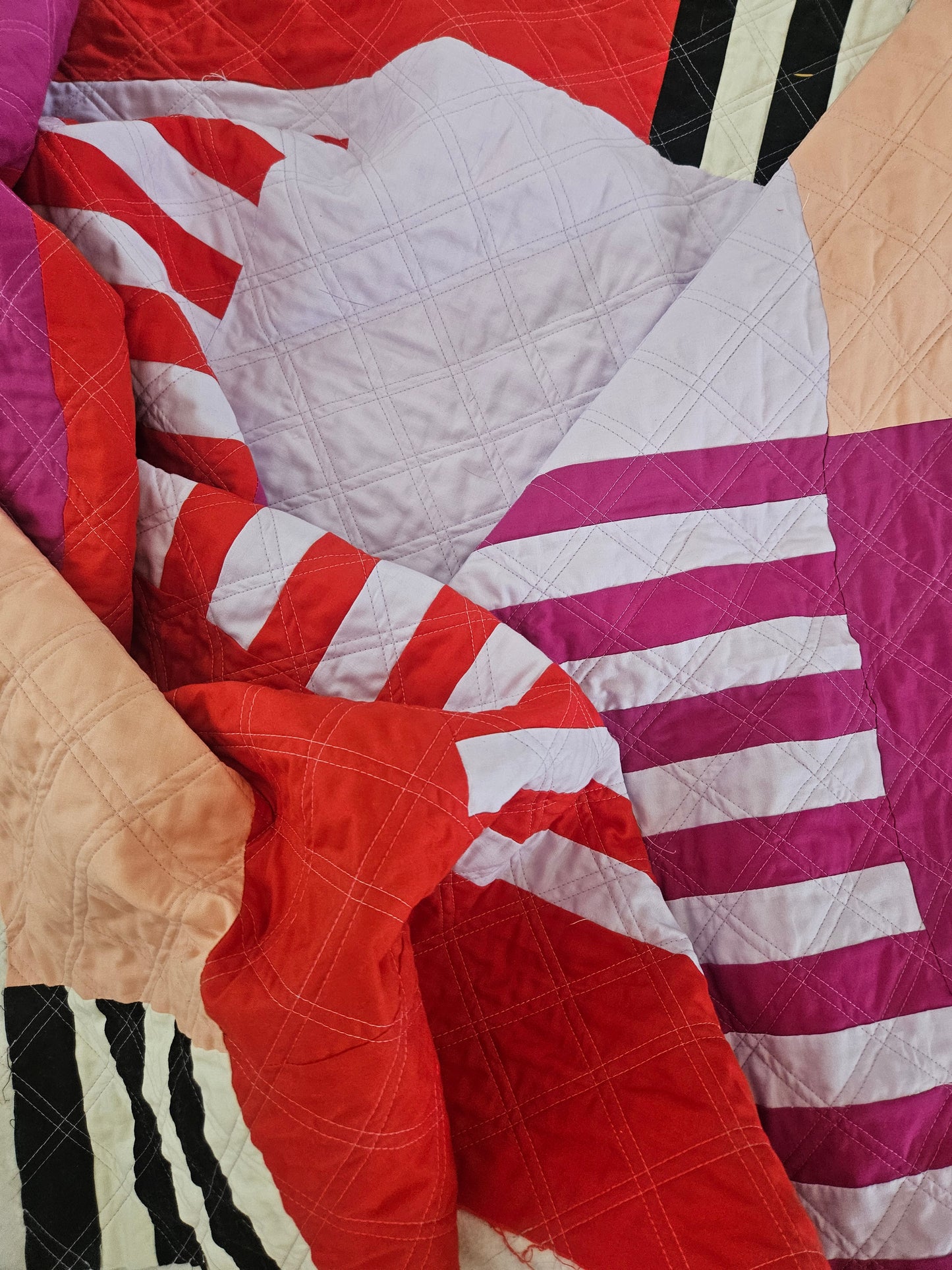 Quilt with multicolored pattern on a bed